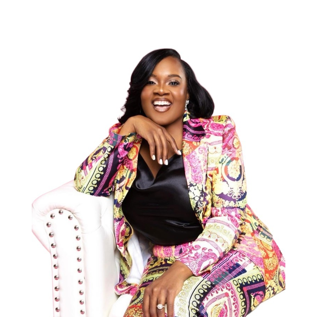 Monika Hicks smiling in a colorful suit